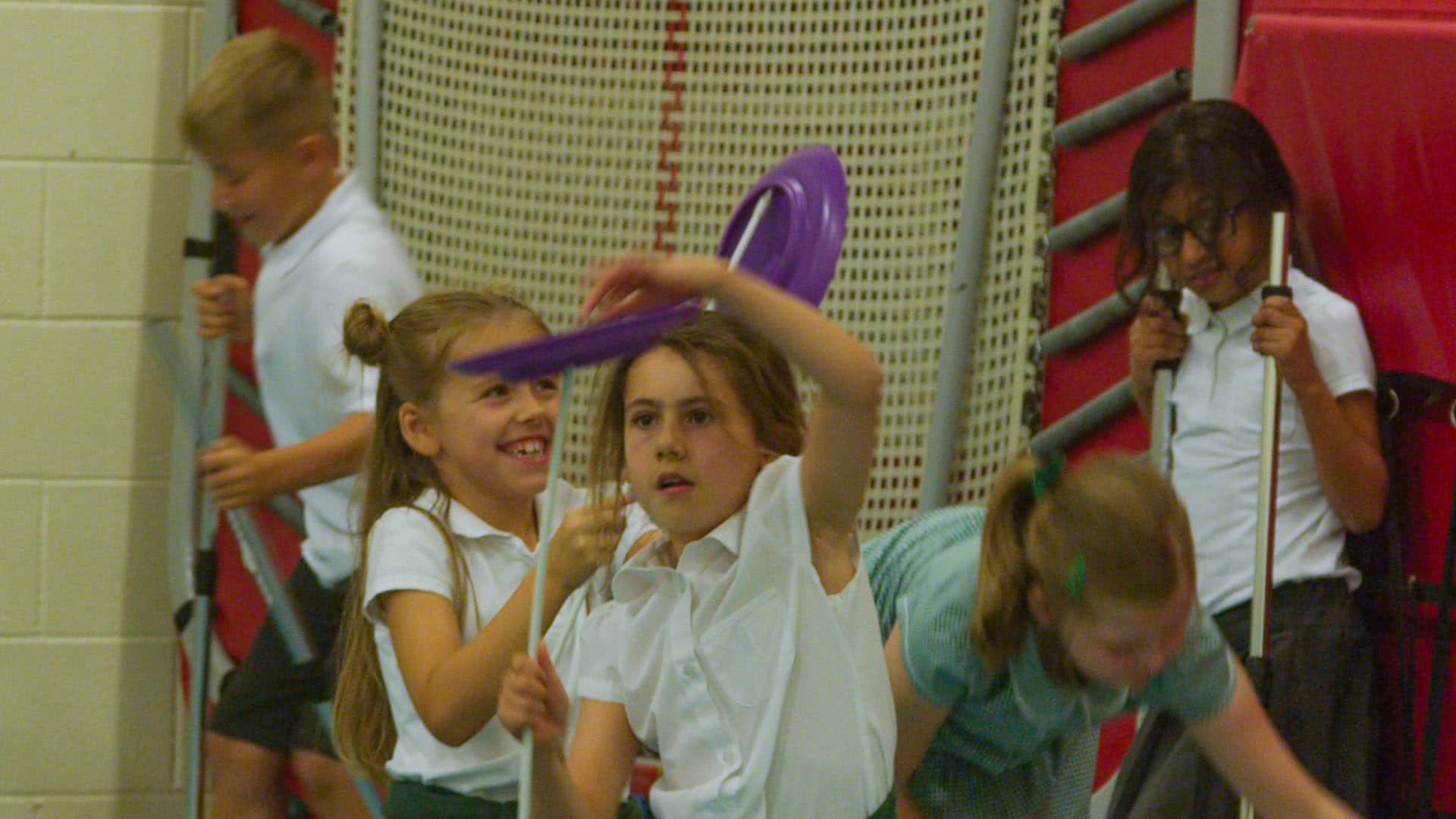 School children balancing purple plate in circus workshop