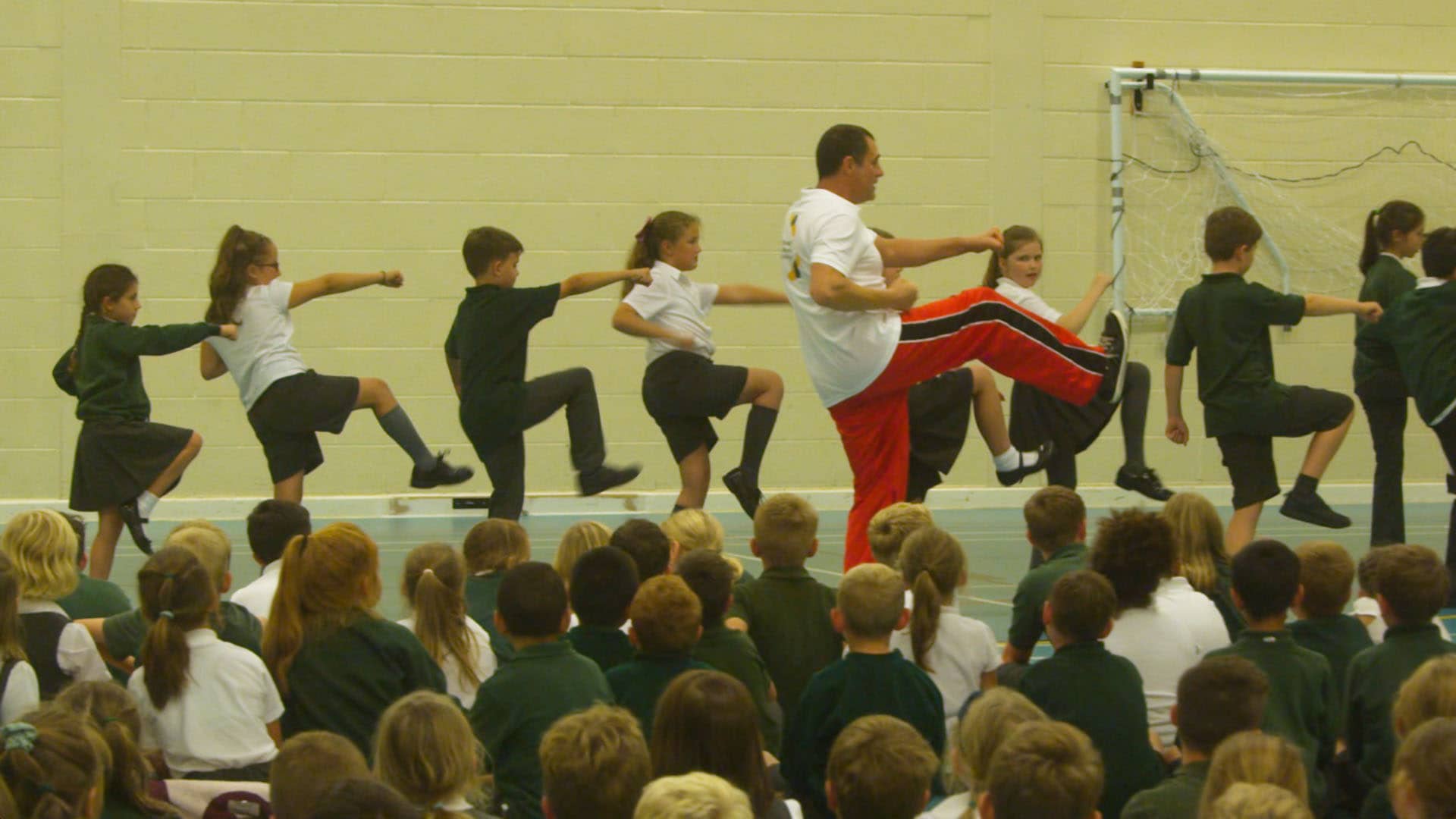 Children and teacher performing martial arts