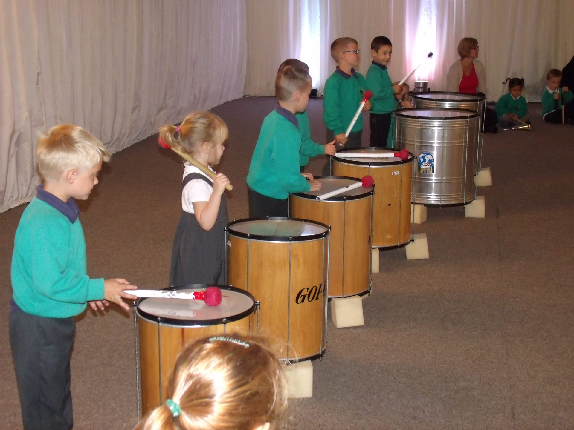 School children playing large samba drums