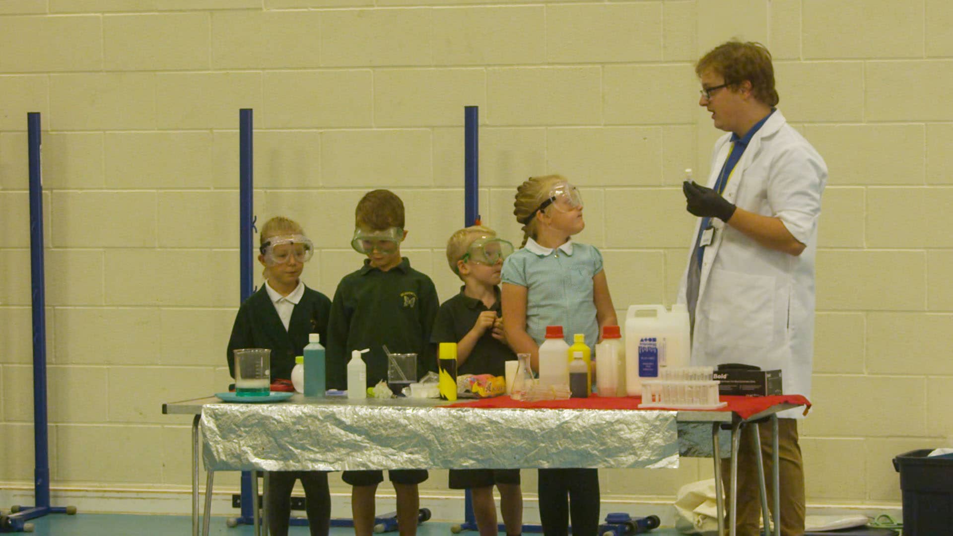 Teacher demonstrating science experiement to children