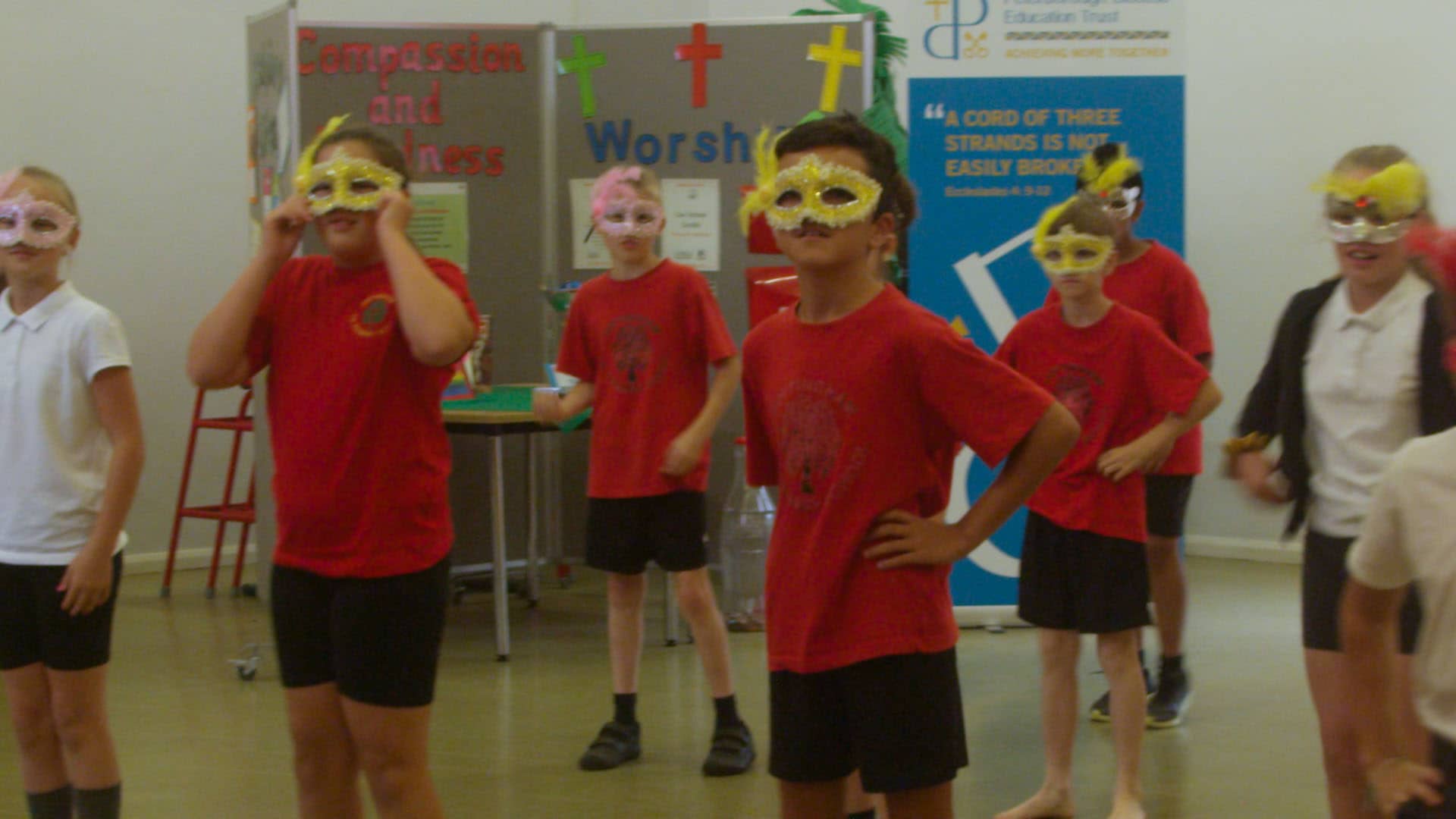 School children wearing dance masks for South American dance workshop