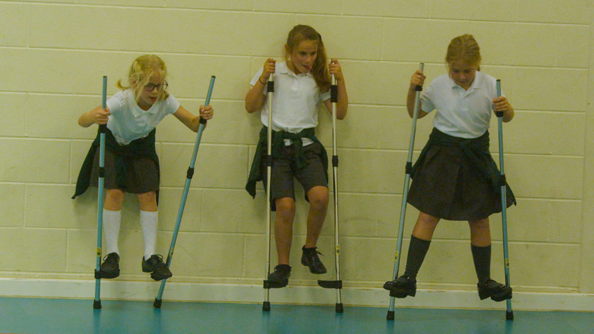 School children using stilts