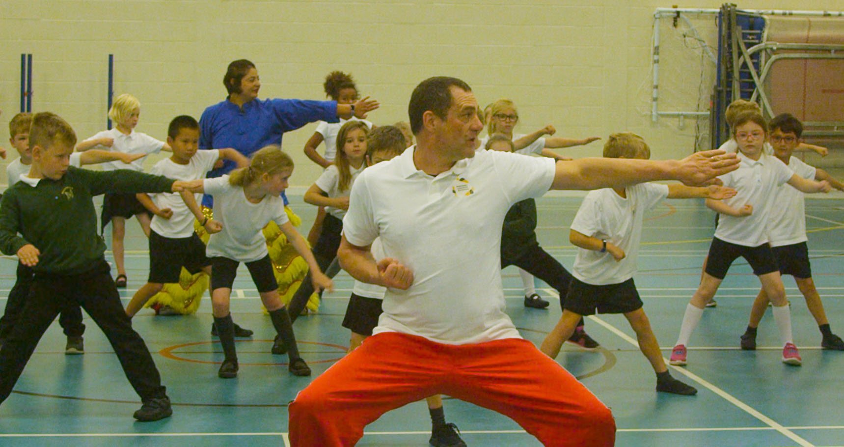 Children and teacher performing martial arts