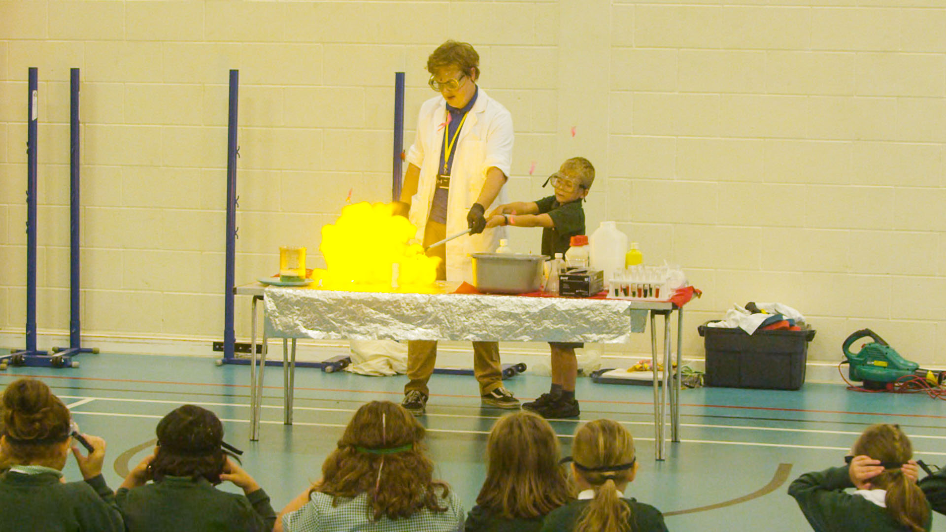 Teacher and student performing a science experiment which creates fire