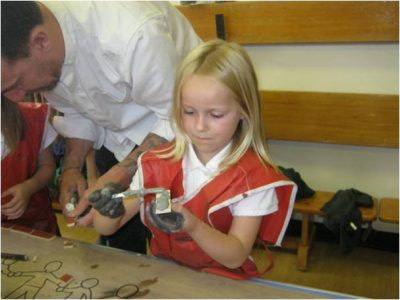 School children making mosaic pieces