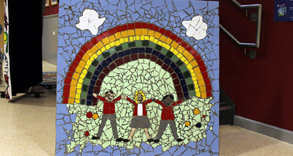 Colourful mosaic spelling out friendship with rainbow and three children