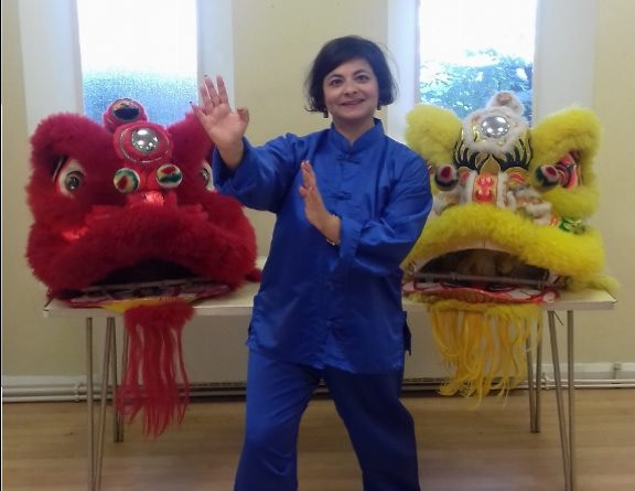 Yellow and red lion dance costumes on table with teacher