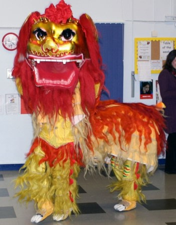 School children with red lion dance costume on